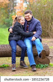 father and daughter, family relaxing outdoor in autumn city park, happy people together, parent and children, they playing and smiling, beautiful nature