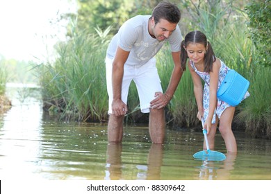 Father and daughter with a fishing net - Powered by Shutterstock