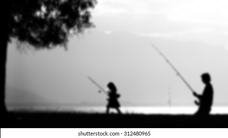 Father Daughter Fishing - Picture Blurred On Purpose Using A Gaussian Blur Filter In Photoshop