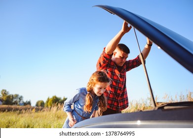 Father And Daughter Fixing Problems With Car During Summer Road Trip. Kid Girl Helping Dad.