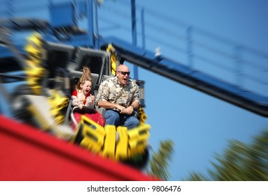 Father And Daughter Having Fun On Rollercoaster