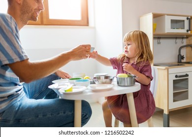 Father and daughter having a tea party at home
 - Powered by Shutterstock