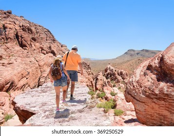 Father And Daughter Hiking In Red Rock Canyon, Nevada, USA. 