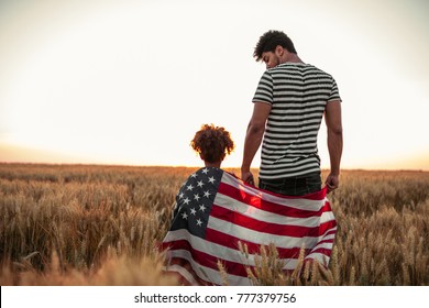 Father and daughter holding American flag
