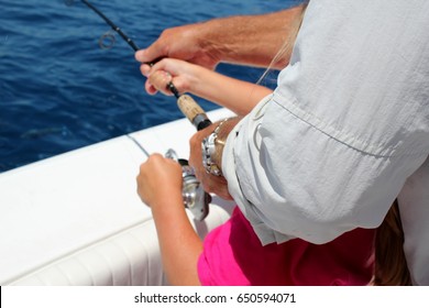 Father And Daughter Holding  Fishing Rod Together While Deep Sea Fishing In The Florida Keys