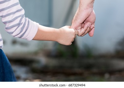 Father and daughter holding hand in hand, care and love concept