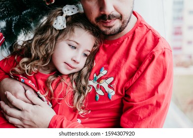 Father And Daughter At Home Wearing Matching Pajamas. Christmas Season