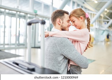 Father And Daughter Hug Each Other In Greeting After A Trip In The Airport Terminal