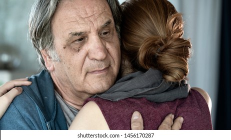 Father and daughter hugging close up view