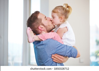 Father And Daughter Kiss At Home