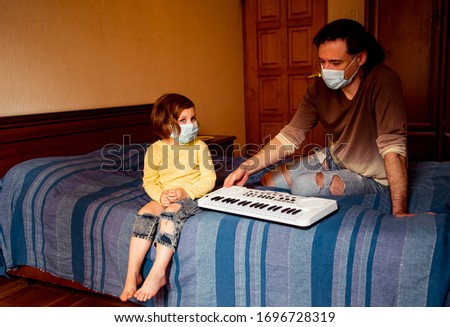 Similar – child girl playing checkers with her dad