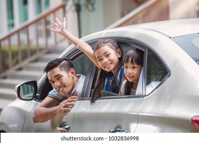 Father and daughter on car and smile from car windows before start family travel trip in holiday, this immage can use for family , travel, car, weekend, and summer concept