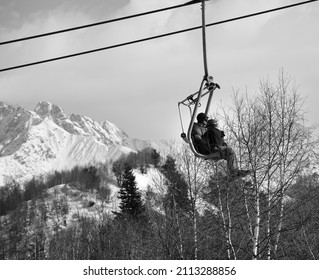 Father And Daughter On Chair-lift And Snowy Mountain At Nice Sunny Day. Caucasus Mountains In Winter. Hatsvali, Svaneti Region Of Georgia. Black And White Toned Image.