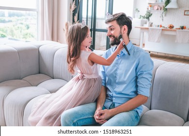 father and daughter playing at home with make up brush - Powered by Shutterstock