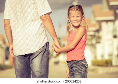 father and daughter playing near a house at the day time - Powered by Shutterstock