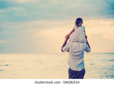 Father and Daughter Playing Together at the Beach at Sunset. Happy Fun Smiling Lifestyle