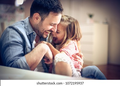 Father and daughter playing together at home. - Shutterstock ID 1072195937