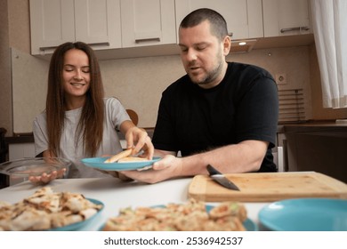 Father and daughter preparing food, indoor cooking and slicing, parent and teenage friendship - Powered by Shutterstock