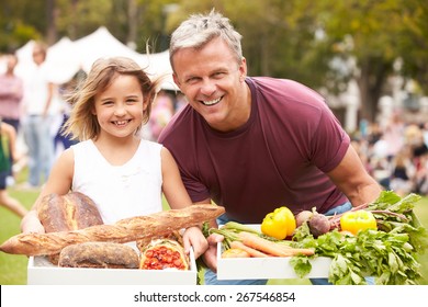 Father And Daughter With Produce From Outdoor Farmers Market - Powered by Shutterstock