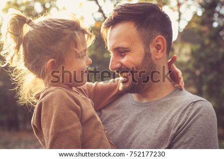 Father and daughter share love. 