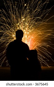 Father And Daughter Silhouetted While Watching Fireworks On The 4th Of July Celebration