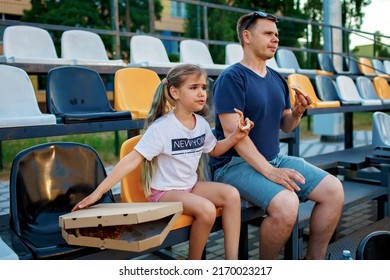 Father With Daughter, Soccer Fans, Watching Football Match, Eating Pizza And Cheering For Local Team At Stadium, Real Emotions, Sports Event And Fan Supporting, Outdoor Lifestyle, Street Food