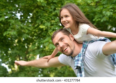 father with daughter in summer park
