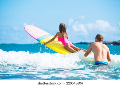 Father and Daughter Surfing Together, Summer Lifestyle Family Concept - Powered by Shutterstock