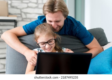 Father And Daughter Using Laptop At Home. Happy Family Moments. Child And Parent Together In Online Video Call. Remote Communication, Virtual Connection In Covid Lockdown. Technology Lifestyle