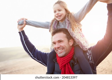 Father And Daughter Walking On Winter Beach - Powered by Shutterstock