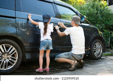 Father And Daughter Wash The Car