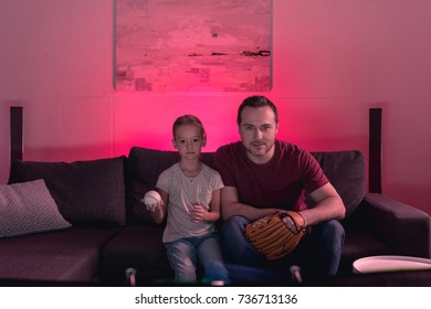 Father And Daughter Watching A Baseball Game At Home