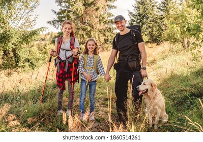 Father with daughters and dog hiking