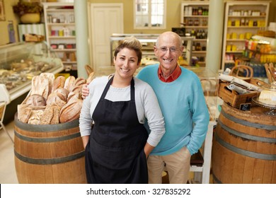 A father and daugther standing together in their deli