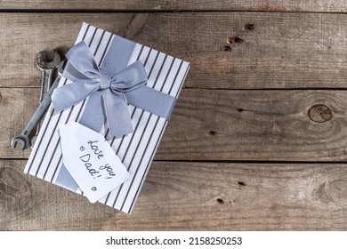 Father Day Greeting Card Background. Fathers Day Concept With Gift Box, Tools And Ties, Coffee Cup, Gift Tag  Love You Dad, On Rustic Wooden Background Top View Copy Space