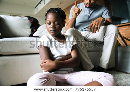 Father disciplining his daughter