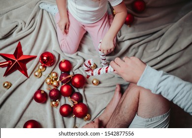 Father and doughter decorate a Christmas tree. Daddy and baby girl play with red star of the chrhistmas tree. New year celebration. - Shutterstock ID 1542877556