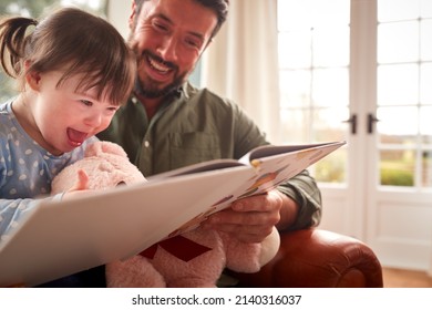 Father With Down Syndrome Daughter Reading Book At Home Together - Powered by Shutterstock