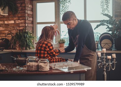 Father With Dracula Makeup And His Little Daughter In Hat Are Ready For Halloween Party.