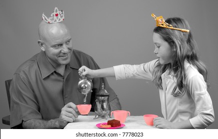 Father Dressed In Tiara Having Princess Tea Party With Daughter