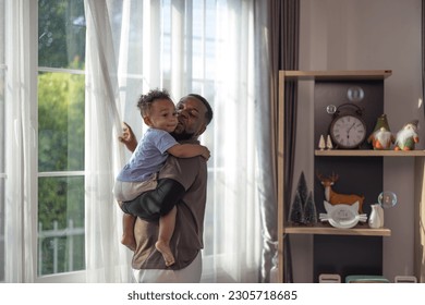 The father embraced and carefully picked up his young son with tenderness and care. Giving direction and protection. Balancing both physical and emotional needs. Love is given without conditions. - Powered by Shutterstock