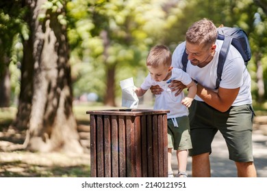 Father encourages son to throw garbage into a bin and recycle it. - Powered by Shutterstock