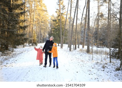 A father enjoys a leisurely walk with his two children through a beautiful snowy forest. The scene captures the joy of family time amidst the serene winter landscape, with snow-covered trees creating - Powered by Shutterstock