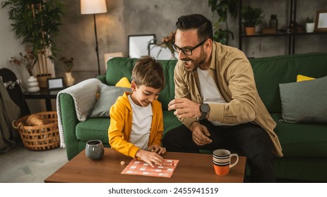 Father with eyeglasses and son caucasian play board game together at home happy enjoy - Powered by Shutterstock