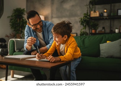 Father with eyeglasses and son do homework and learn together at home - Powered by Shutterstock