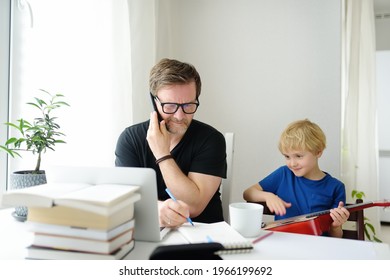 Father Freelancer Working From Home With Laptop During Quarantine. Mischief Son Distracts. Home Office And Parenthood. Exhausted Parent With Hyperactive Child. Chaos With Kids While Isolation.