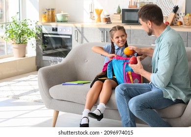 Father getting his little daughter ready for school - Powered by Shutterstock