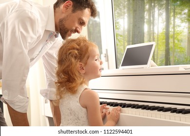 A Father Giving Daughter Piano Lessons