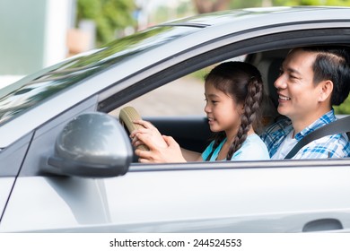 Father Giving His Daughter Driving Lessons