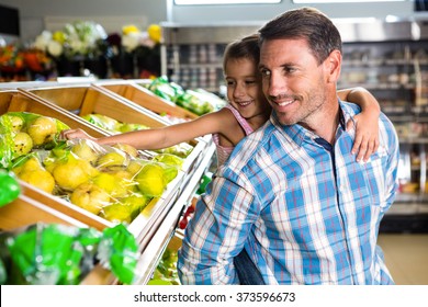 Father Giving Piggy Back To Daughter In Grocery Store